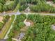 House nestled in a wooded neighborhood with a paved road at 920 Eskew Rd, Mcdonough, GA 30252