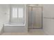 Bathroom featuring a corner soaking tub and a separate shower stall at 920 Eskew Rd, Mcdonough, GA 30252