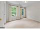Bright bedroom with two large windows and neutral colored carpeting at 920 Eskew Rd, Mcdonough, GA 30252