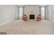 Primary bedroom with fireplace and large windows with curtains at 920 Eskew Rd, Mcdonough, GA 30252