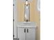 Powder room with pedestal sink and vertical mirror at 920 Eskew Rd, Mcdonough, GA 30252