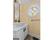 Small bathroom with pedestal sink and stained glass window at 920 Eskew Rd, Mcdonough, GA 30252