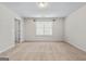 Spacious bedroom with carpet, large window, and door to bathroom at 920 Eskew Rd, Mcdonough, GA 30252