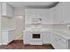 White kitchen with ample cabinetry, hardwood floors, and an electric range at 920 Eskew Rd, Mcdonough, GA 30252
