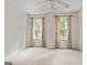 Well-lit bedroom featuring neutral walls and carpeting, plus two large windows at 920 Eskew Rd, Mcdonough, GA 30252