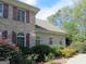 Brick exterior wall with landscaping and burgundy shutters at 5335 Saville Dr, Acworth, GA 30101