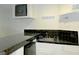 Basement bar with black tile, sink, and mini fridge at 5335 Saville Dr, Acworth, GA 30101