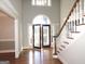 Bright entryway with hardwood floors, a grand staircase, and double doors at 5335 Saville Dr, Acworth, GA 30101