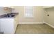 Laundry room with cabinets, sink, and tile floor at 5335 Saville Dr, Acworth, GA 30101