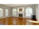Living room with hardwood floors, fireplace, and arched windows at 5335 Saville Dr, Acworth, GA 30101