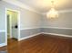 Formal dining room with hardwood floors, chandelier, and access to butler's pantry at 5335 Saville Dr, Acworth, GA 30101