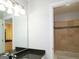 Bathroom with granite vanity, tiled shower/tub combo, and built-in shelving at 5335 Saville Dr, Acworth, GA 30101