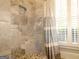 Bathroom with marble shower, built-in seat and window at 5335 Saville Dr, Acworth, GA 30101