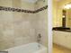 Beige tiled bathroom with shower/tub combo and granite vanity at 5335 Saville Dr, Acworth, GA 30101
