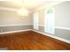 Formal dining room with hardwood floors, elegant chandelier, and plantation shutters at 5335 Saville Dr, Acworth, GA 30101