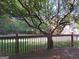 Deck with wooden railing and tree shade at 5335 Saville Dr, Acworth, GA 30101