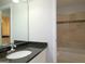 Bathroom with granite vanity, tiled shower/tub combo, and built-in shelving at 5335 Saville Dr, Acworth, GA 30101