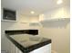 Basement bar with black tile and glass countertop at 5335 Saville Dr, Acworth, GA 30101