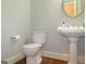Elegant powder room with pedestal sink and hardwood floor at 5335 Saville Dr, Acworth, GA 30101