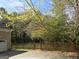 Side yard view of home with wooden fence and trees at 5335 Saville Dr, Acworth, GA 30101