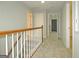 Upstairs hallway with carpeted flooring and wooden railings at 5335 Saville Dr, Acworth, GA 30101