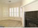 Bright sitting room featuring a fireplace and large windows with plantation shutters at 5335 Saville Dr, Acworth, GA 30101