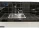 Stainless steel sink with black tile backsplash at 5335 Saville Dr, Acworth, GA 30101