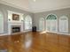 Living room with hardwood floors, fireplace, and arched windows at 5335 Saville Dr, Acworth, GA 30101