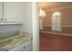 Butlers pantry with granite countertop and white cabinets at 5335 Saville Dr, Acworth, GA 30101