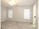 Spacious bedroom with gray carpet, plantation shutters, and ceiling fan at 5335 Saville Dr, Acworth, GA 30101