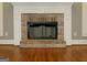 Elegant brick fireplace with white mantel in a living room with hardwood floors at 5335 Saville Dr, Acworth, GA 30101