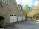 Three-car garage with white doors and brick exterior at 5335 Saville Dr, Acworth, GA 30101