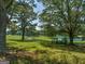 Long driveway leading to home, lined with trees and fencing, overlooking pond at 655 Mcdonough Rd, Hampton, GA 30228
