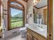 Bathroom with vanity, toilet and shower, and window view at 655 Mcdonough Rd, Hampton, GA 30228