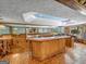 Basement bar with wood cabinetry, tile flooring, and a large countertop at 655 Mcdonough Rd, Hampton, GA 30228