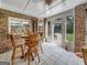 Bright sunroom with brick walls, tile floor, and wooden furniture at 655 Mcdonough Rd, Hampton, GA 30228