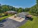 Aerial view of house, detached garage, and expansive property with trees and pond at 655 Mcdonough Rd, Hampton, GA 30228