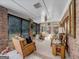 Bright sunroom with wicker furniture and view of the backyard at 655 Mcdonough Rd, Hampton, GA 30228