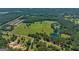 Aerial view of a large property with two ponds, open fields, and nearby homes and roads at 655 Mcdonough Rd, Hampton, GA 30228