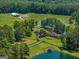 Aerial view of property showcasing home, outbuildings, and large pond at 655 Mcdonough Rd, Hampton, GA 30228