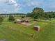 Aerial view showcasing a ranch home on a spacious lot with a private drive and storage shed at 655 Mcdonough Rd, Hampton, GA 30228