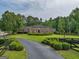 Brick home with circular driveway and manicured landscaping at 655 Mcdonough Rd, Hampton, GA 30228