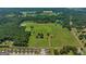 Aerial view of a large property with open fields, ponds, and a home at 655 Mcdonough Rd, Hampton, GA 30228