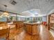 Basement bar with wood cabinetry, tile flooring, and a large countertop at 655 Mcdonough Rd, Hampton, GA 30228