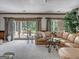 Relaxing basement sitting area with comfortable sectional sofa and sliding glass doors at 655 Mcdonough Rd, Hampton, GA 30228