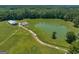 Aerial view of pond, barn, and surrounding property at 655 Mcdonough Rd, Hampton, GA 30228