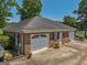 Two-car attached brick garage with ample parking space at 655 Mcdonough Rd, Hampton, GA 30228