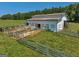 White barn with multiple stalls and fencing at 655 Mcdonough Rd, Hampton, GA 30228