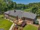 Home's back features a deck, large windows, and lush landscaping at 655 Mcdonough Rd, Hampton, GA 30228