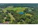 Aerial view of large property with pond and surrounding landscape at 655 Mcdonough Rd, Hampton, GA 30228
